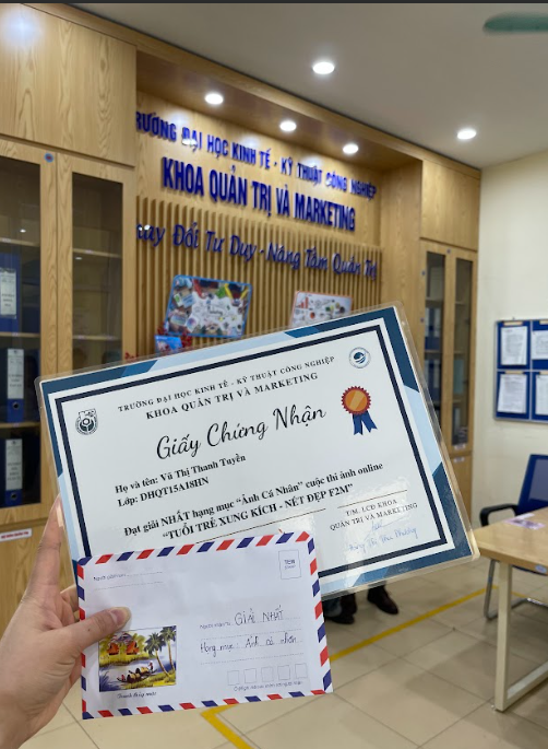 A hand holding a certificate and envelope AI-generated content may be incorrect.
